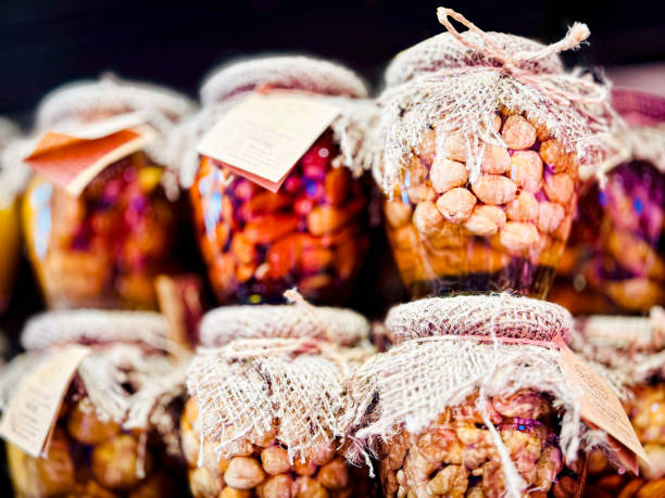 A collection of honey jars filled with nuts, figs, and tied with twine