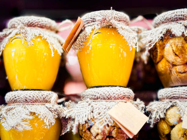A collection of honey jars filled with nuts, figs, and tied with twine