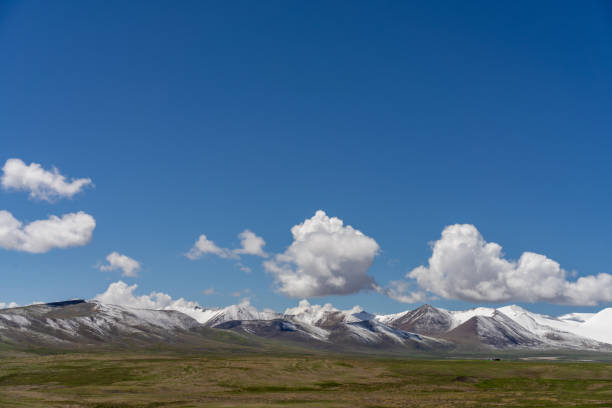 istock Snow-capped mountains and meadows on the plateau under blue sky and white clouds 2158699186