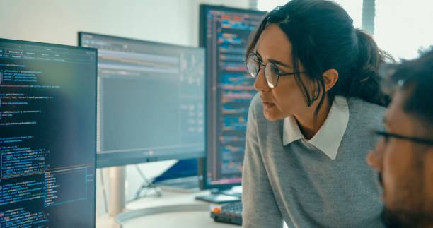 istock Closeup of tech team professionals collaborate discuss software development strategies in modern office. Software developer, artificial intelligence and programming. 2158703028