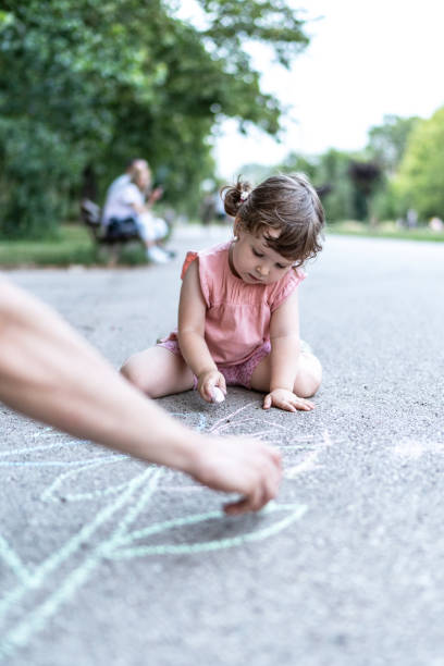 istock Father and daughter drawing with chalk 2158703223