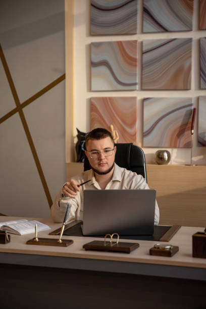 istock White man in the office working with a laptop 2158703813