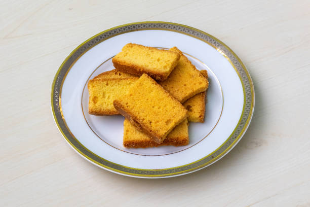 istock Tasty crispy dry cake biscuits on a white plate on wooden background. 2158704863