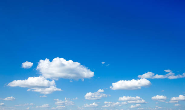 istock white fluffy clouds with rainbow in the blue sky 2158705240