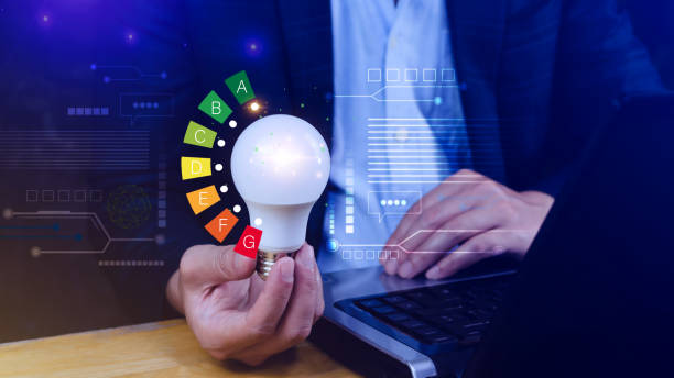 istock Energy efficiency concept, House energy efficiency or energy saving rate for reduce carbon footprint, hold light bulb with energy efficient rating class concept save cost green energy. 2158713681