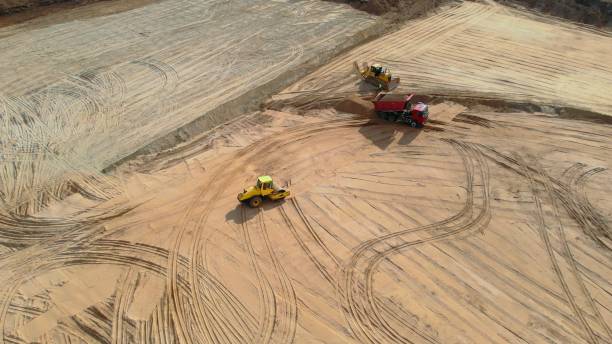istock Construction site involves moving heavy machinery like bulldozers and trucks for earth excavation and clearing. Its large operation preparing ground for infrastructure development. Drone view 2158714148