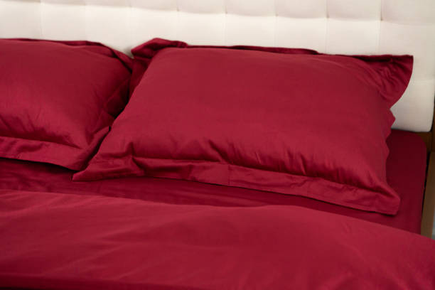 istock red cotton bed satin linen pillows on the bed textile background 2158714440
