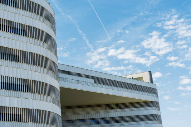 istock Modern Architecture: Curved Office Building Against Blue Sky with Plane Trails 2158714894