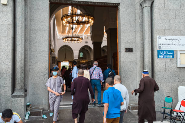 Medina, Saudi Arabia - December 22, 2022: Visitors approach the revered Quba Mosque, a beacon of Islamic heritage.