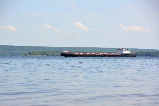 a large freight ship is sailing on a lake copy space