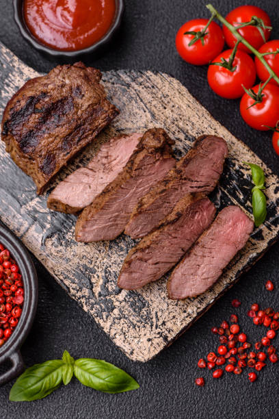 istock Fresh juicy delicious beef steak on a dark background 2158716773