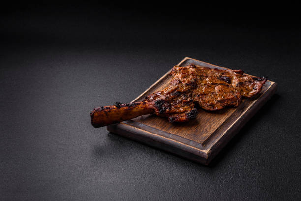 istock Juicy beef tomahawk steak on the bone baked on the grill 2158716777