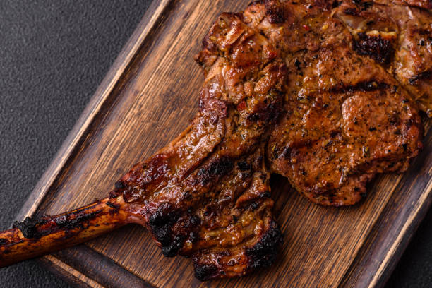istock Juicy beef tomahawk steak on the bone baked on the grill 2158716784