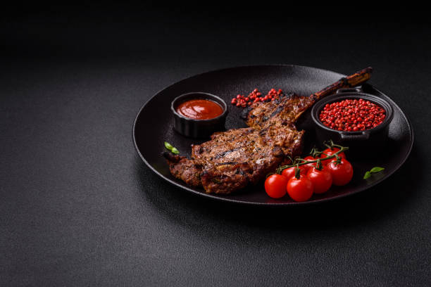 istock Juicy beef tomahawk steak on the bone baked on the grill 2158716810