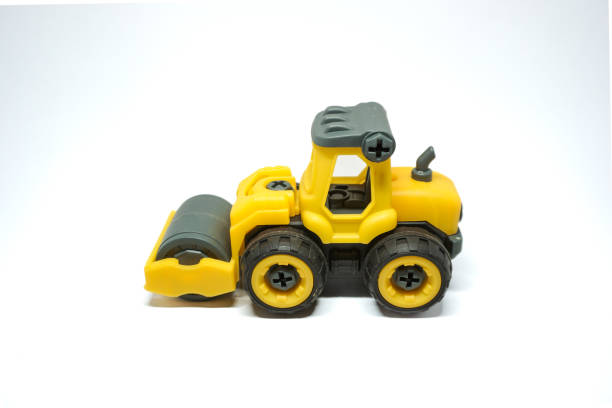 istock yellow tendem roller toy on white background. Tandem roller or road roller toy for kids 2158717807