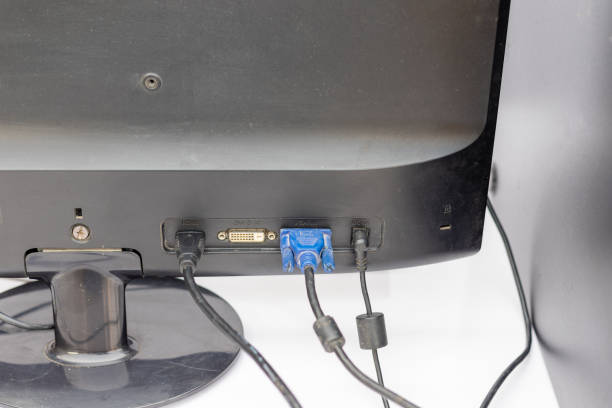 Backside View of a Computer Monitor with Connected Cables.