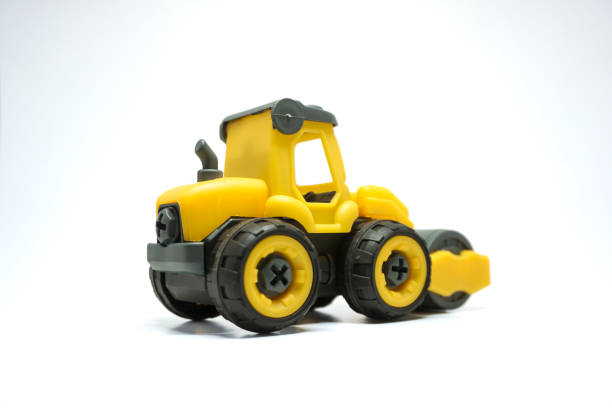 istock yellow tendem roller toy on white background. Tandem roller or road roller toy for kids 2158717831