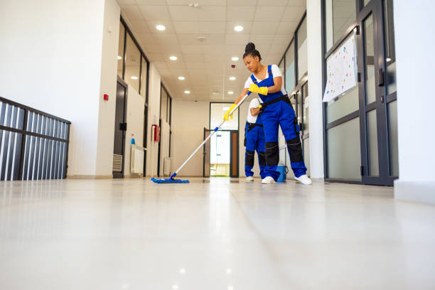Janitors cleaning the  floor in school hallway
