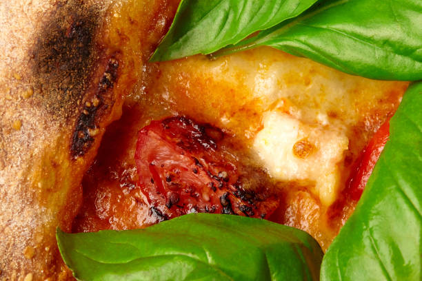 Closeup of tom yam pizza with tomato, shrimps, melted cheese and fresh basil