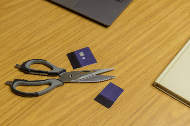 istock Cut credit card next to scissors on a table. 2158721784