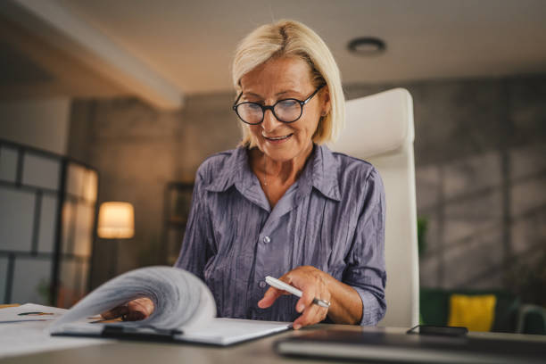 istock Mature woman work from home and sign insurance,document on clipboard 2158722146