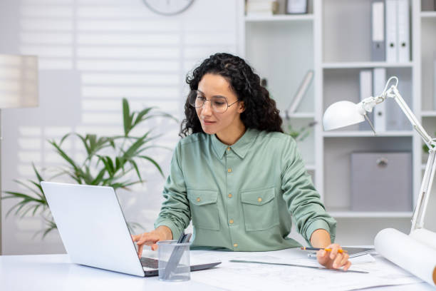 istock Professional woman working on laptop in modern office environment 2158723758
