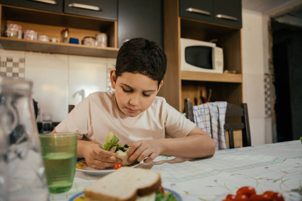 istock Child eating a healthy snack at home 2158725495