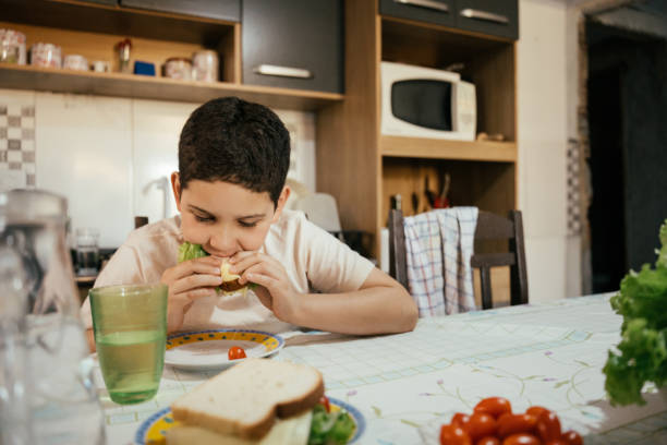 istock Child eating a healthy snack at home 2158725522