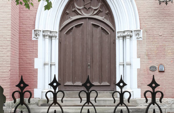The entrance to a historic church building with a spiked-iron fence in Covington, Kentucky
