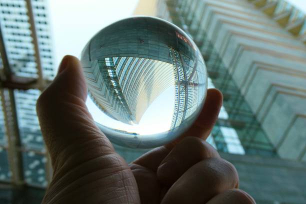 istock Hand holding crystal ball against skyscraper 2158734219