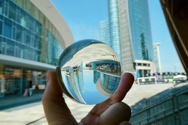 istock Hand holding crystal ball against skyscraper 2158734418