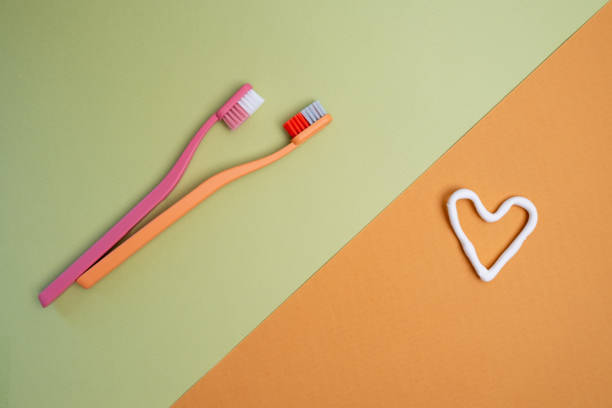istock Colored toothbrushes on a color background. Replace your old toothbrush with a new one. Old and new toothbrushes. Dental health and hygiene concept 2158735014
