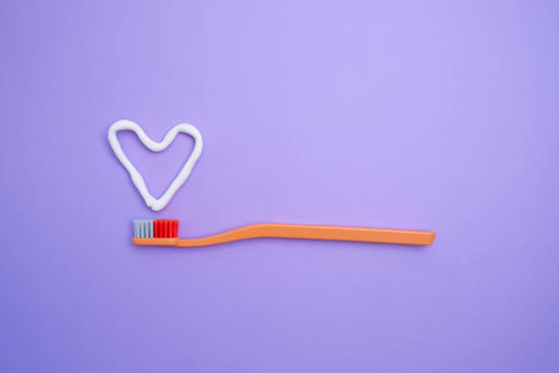 istock Colored toothbrushes on a color background. Replace your old toothbrush with a new one. Old and new toothbrushes. Dental health and hygiene concept 2158735015