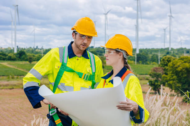 istock Engineer team working group survey at wind turbine clean power generator service maintenance wind mill outdoor. 2158738721