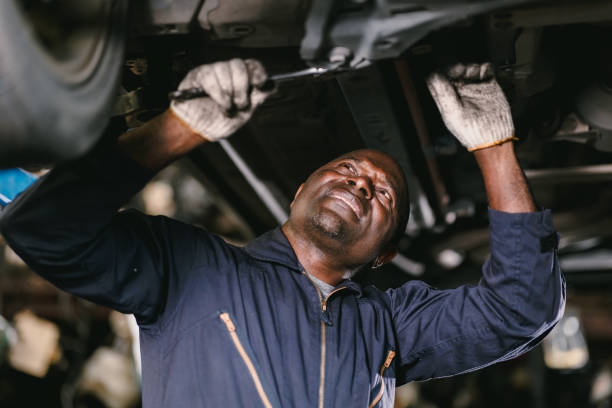 istock Mechanic Working Repair Vehicle in Car Service. Professional Worker Using Ratchet Underneath Car in Workshop 2158738757