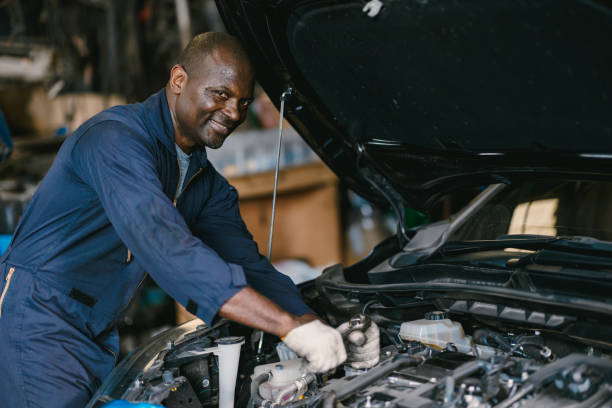 istock African Black man Car Service Mechanic Looking Happy Smiling Working in Garage Workshop. 2158738787