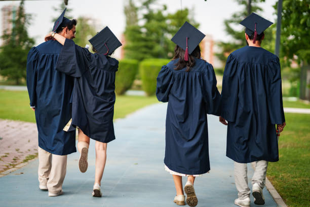 istock Graduating young people from back, are leaving the campus 2158742295