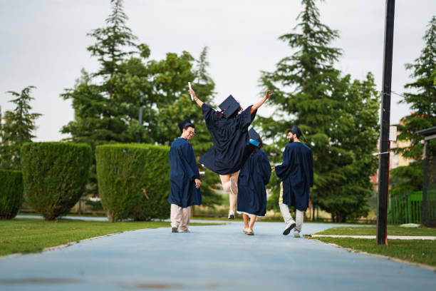 istock Graduating young people from back, are leaving the campus 2158742508
