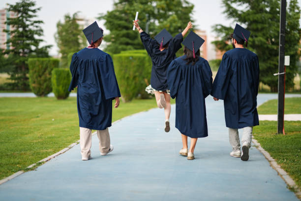 istock Graduating young people from back, are leaving the campus 2158742818