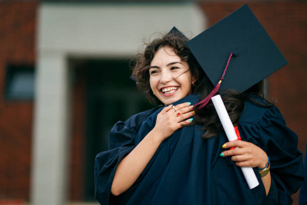 istock Graduating people are hugging each other at the prom. 2158742834
