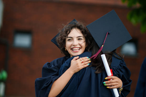 istock Graduating people are hugging each other at the prom. 2158742845