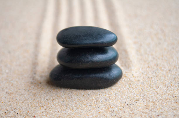 istock Close up of zen stones on sand with customizable space for text 2158745688