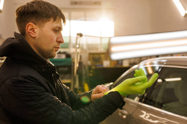 istock An engineer in green gloves fixing a car in a garage 2158746275