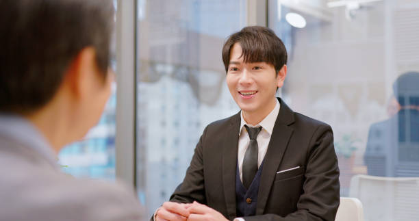 asian confident male new graduate has job interview with business executive