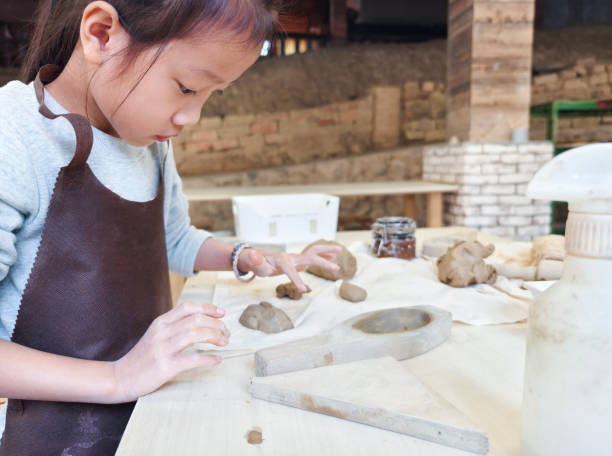 istock A girl is kneading clay in the pottery classroom 2158749086