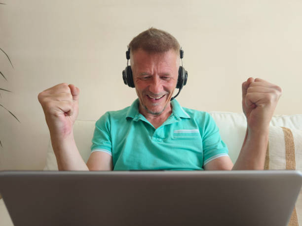 istock Man play online video games at his home 2158751593