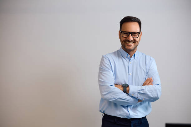 istock Happy CEO with arms crossed in the office looking at camera. 2158752215
