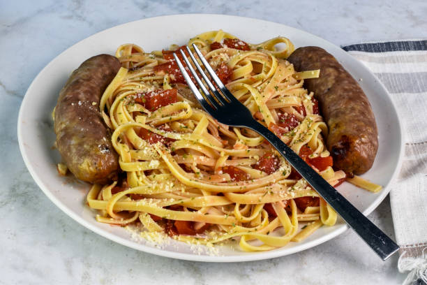 istock fettuccine  with diced tomatoes a nd with  sausage 2158754033