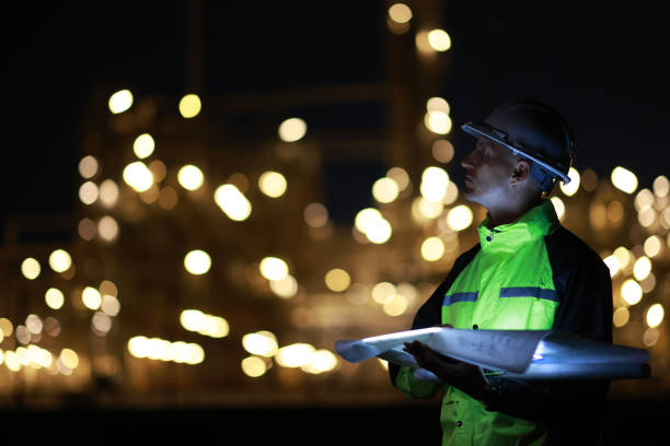 istock A smart chemical engineer using a digital tablet working late at night with a refinery plant in the background.Engineer working on outdoor building site at night. Engineers working late in power plant 2158755996