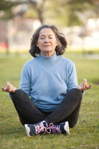 istock Mature woman meditating outdoors 2158763914